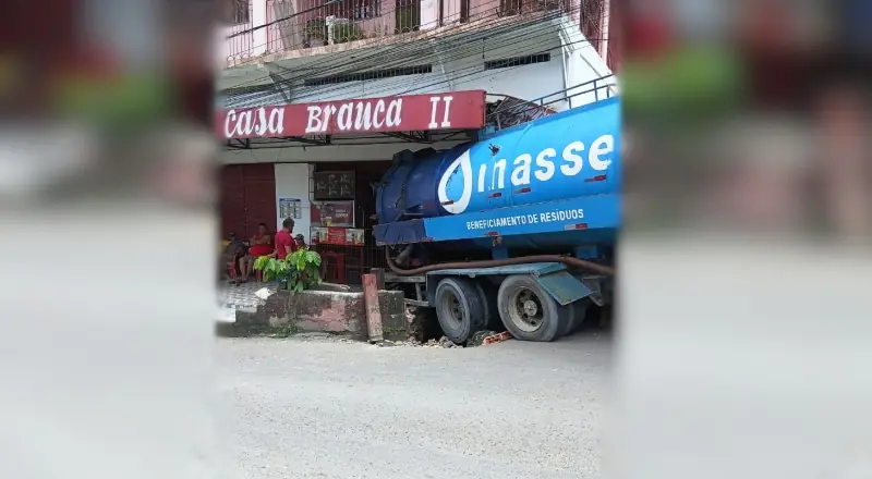 Caminhão de resíduos invade calçada e causa dano ao comércio